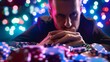 © Oranee  - A man deeply contemplating while looking at a pile of poker chips, set against the vibrant lights of a casino.