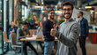 © mister - A happy young male employee in casual shows a thumbs up