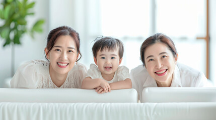 Wall Mural - Three generations of an Asian family smiling together on a couch. The scene is warm and affectionate