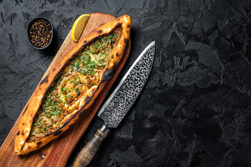 Wall Mural - Turkish pide pie with beef meat and vegetables. Black background. Top view. Copy space