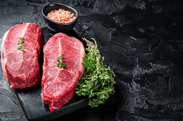 Wall Mural - Raw wagyu oyster top blade steaks, organic beef meat. Black background. Top View. Copy space