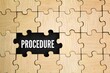 © Fauzi - wooden puzzle and a hole in the middle with the word procedure. Business procedures concept