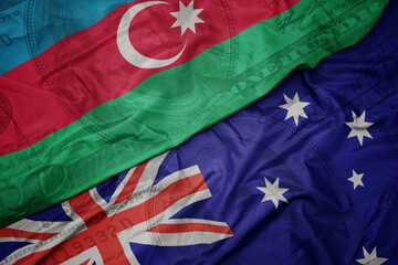 Wall Mural - waving colorful flag of azerbaijan and national flag of australia on the dollar money background. finance concept.