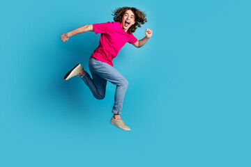 Sticker - Full size photo of nice young man jump run empty space wear t-shirt isolated on blue color background