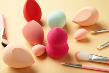 Wall Mural - Makeup brush and beauty makeup sponges on beige background. Beauty and makeup concept