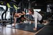 © Quality Stock Arts - Sport Young man and women friend One handed push ups, Enjoy Trainer together Healthcare at fitness gym.