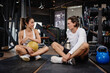 © Quality Stock Arts - Healthcare Sport Young man and women friend relaxing, Trainer talking at fitness gym brake enjoy together.
