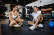 © Quality Stock Arts - Healthcare Sport Young man and women friend relaxing, Trainer talking at fitness gym brake enjoy together.