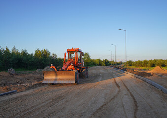 Sticker - Roadworks. Motor Grader on road construction in forest. Greyder leveling the ground during roadworks. Heavy machinery and construction equipment for grading. Earthworks grader machine on Roadworks.