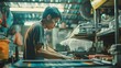 © Sasa Visual - A young man works on a sewing machine in a small shop