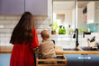 © Austockphoto - mother and young son cooking together in kitchen doing dinner prep