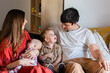 © Austockphoto - Happy young family together on the couch in loungeroom inside their home