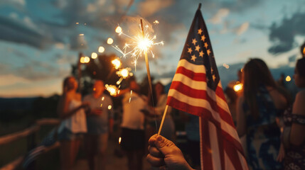 Close up of a person holding an American flag and sparkler celebrating 4th July independence day