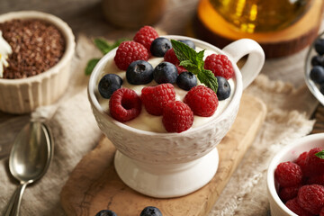Wall Mural - Cottage cheese blended with flax seed oil in a bowl, with fresh raspberries and blueberries. Budwig diet.