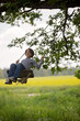 © Tomsickova - Sweet child, preteen boy, swinging on a wooden swing