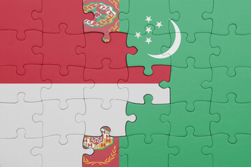 puzzle with the colourful national flag of turkmenistan and flag of indonesia.