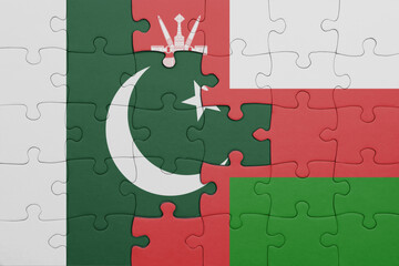 Wall Mural - puzzle with the colourful national flag of oman and flag of pakistan .