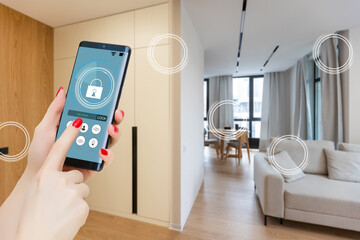 Wall Mural - Home temperature, safety and environment control on mobile app. Smart phone in woman hand. Living room in background