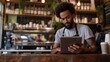 © HQ2X2 - Barista Using Tablet in Coffee ShopCafe Worker Managing Orders on Digital Device