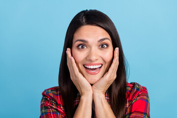 Canvas Print - Photo portrait of attractive mature woman happy wearing checkered red shirt touch cheeks amazed isolated on blue color background