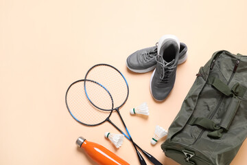 Wall Mural - Badminton set, bag, sneakers and bottle on beige background, flat lay. Space for text