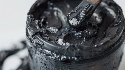 Poster - A close-up shot of a black paint can with a brush inside, great for DIY or home decor projects