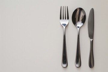 Poster - A set of utensils including knife, fork and spoon placed on a table