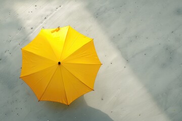 Poster - A bright yellow umbrella sits alone on a white background, perfect for adding a pop of color to any design