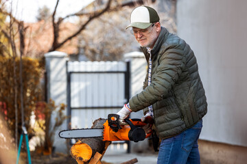 Man cutting wood with saw, dust and movements. Chainsaw.