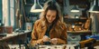 © grigoryepremyan - Beautiful female jeweler making jewelry in her workshop.