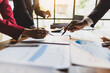 © Wasan - Business meeting, Company executives meeting discussing strategic analysis and business planning, group of people working with paperwork on a board room table at a business presentation or seminar.