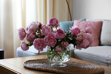Wall Mural - Beautiful pink peonies in vase on table at home. Interior design