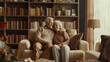 © VK Studio - An elderly couple sits together on a cozy couch in a home library, exuding love and companionship.