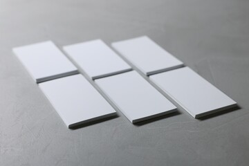 Wall Mural - Blank business cards on light grey textured table, closeup. Mockup for design