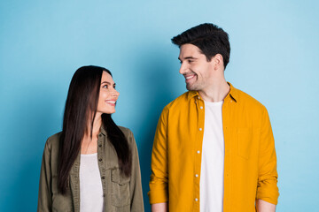 Wall Mural - Portrait of two young people look each other wear shirt isolated on blue color background