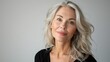 © Photolife   - portrait of a beautiful middle-aged Caucasian woman with blond long hair, well-groomed facial skin, studio portrait white background.