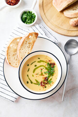 Wall Mural - Bowl of potato soup with parsley and bacon with toasted bread croutons in white bowl. Comfort meal