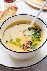 Wall Mural - Bowl of potato soup with parsley and bacon with toasted bread croutons in white bowl. Comfort meal