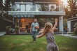 © Olsek - Happy family moment in modern backyard. Father plays with daughter on a sunny day. Family and home style form this bright scene. Ideal for lifestyle, modern living promotions. Generative AI