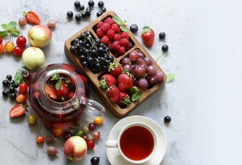 Sticker - fruit tea in a teapot with fresh berries