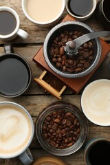 Wall Mural - Different coffee drinks in cups, beans and manual grinder on wooden table, flat lay