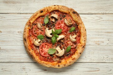 Wall Mural - Tasty pizza with basil, mushrooms and tomato on wooden rustic table, top view