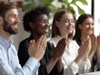 © Business Pics - The company's employees clap their hands as a sign of success, support, and achievements. A team of cheerful smiling multiethnic group of people applauds at a briefing in the office.