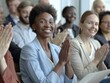© Business Pics - The company's employees clap their hands as a sign of success, support, and achievements. A team of cheerful smiling multiethnic group of people applauds at a briefing in the office.