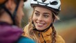© Pinklife - A woman wearing a helmet, smiling warmly, is captured during an outdoor biking activity, depicting the joy and freedom experienced during cycling.