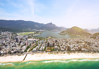Wall Mural - Aerial view, beach and buildings in city, mountain and architecture in Brazil, tourism and destination. Location, above and travel in Rio De Janeiro, water and outdoor for vacation and explore