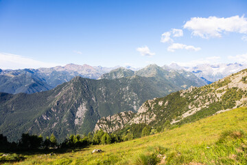 Panorama of Italian Alps with blue sky and cloud. Calm landscape, tranquil scenic view.