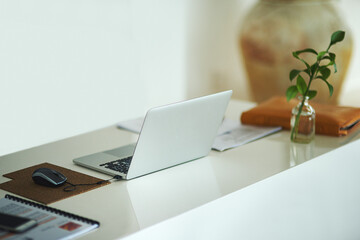 Poster - Laptop, plant on table and empty house for remote work, internet and research. Computer, documents on desk and setup in home office with paper for freelance, email and technology in interior room