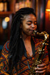 © Thumbs - Afro american woman Playing Saxophone at Night, Music Performance, Joyful