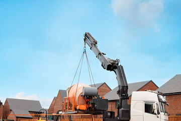 Wall Mural - Crane Lifting Cement Mixer at New Home Construction Site